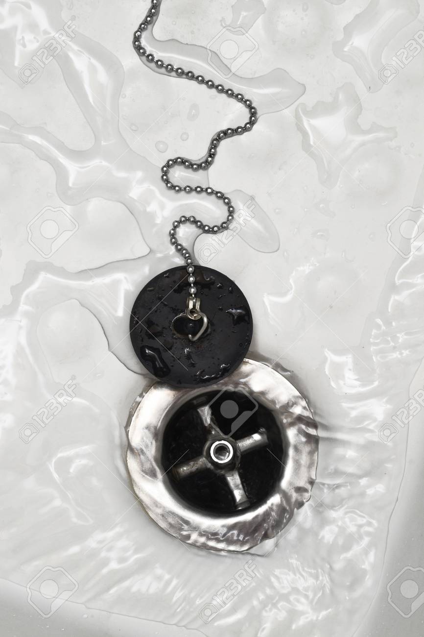 Draining water with the drain rubber plug on shower bath.